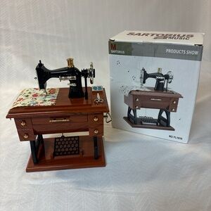 Sartorius mini musical trundle sewing machine model YL-1010.